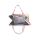 interior of metallic gold and white pinstripe lunch bag with light pink handles