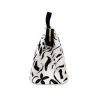 Sideview of white lunch bag with black floral pattern on a white background