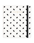 Notebook with black dot pattern and a black strap on a white background