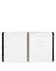 Spiral-bound notebook with black binding on a white background