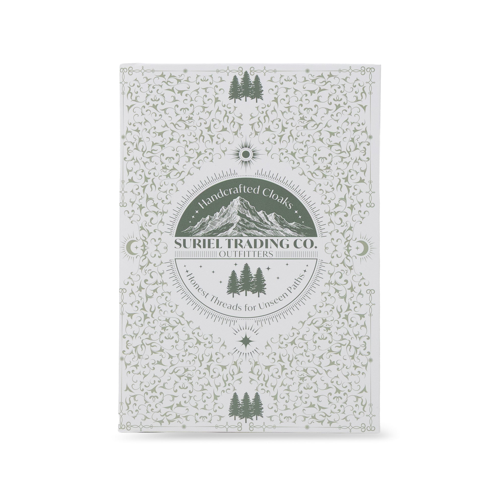 A rectangular book packaging with a white background and an intricate sage green floral and mountain pattern. The center features a circular logo for 'Suriel Trading Co.