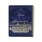 Notebook with decorative cover featuring text and architectural illustration on a white background
