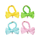 Four colorful hair bows with scrunchies on a white background