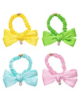 Four colorful hair bows with scrunchies on a white background