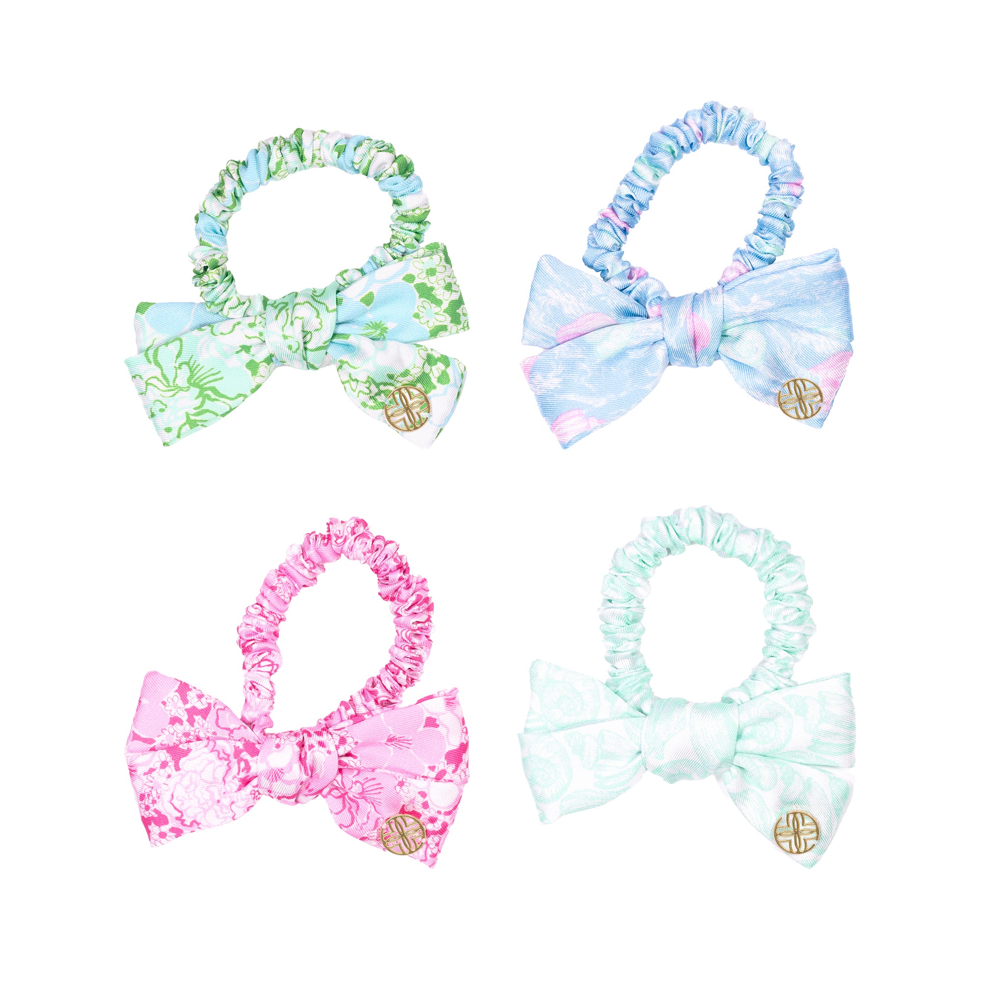 Four colorful hair bows with headbands on a white background
