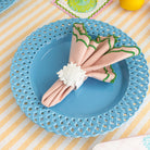 white sun napkin ring with a pink and green napkin inside