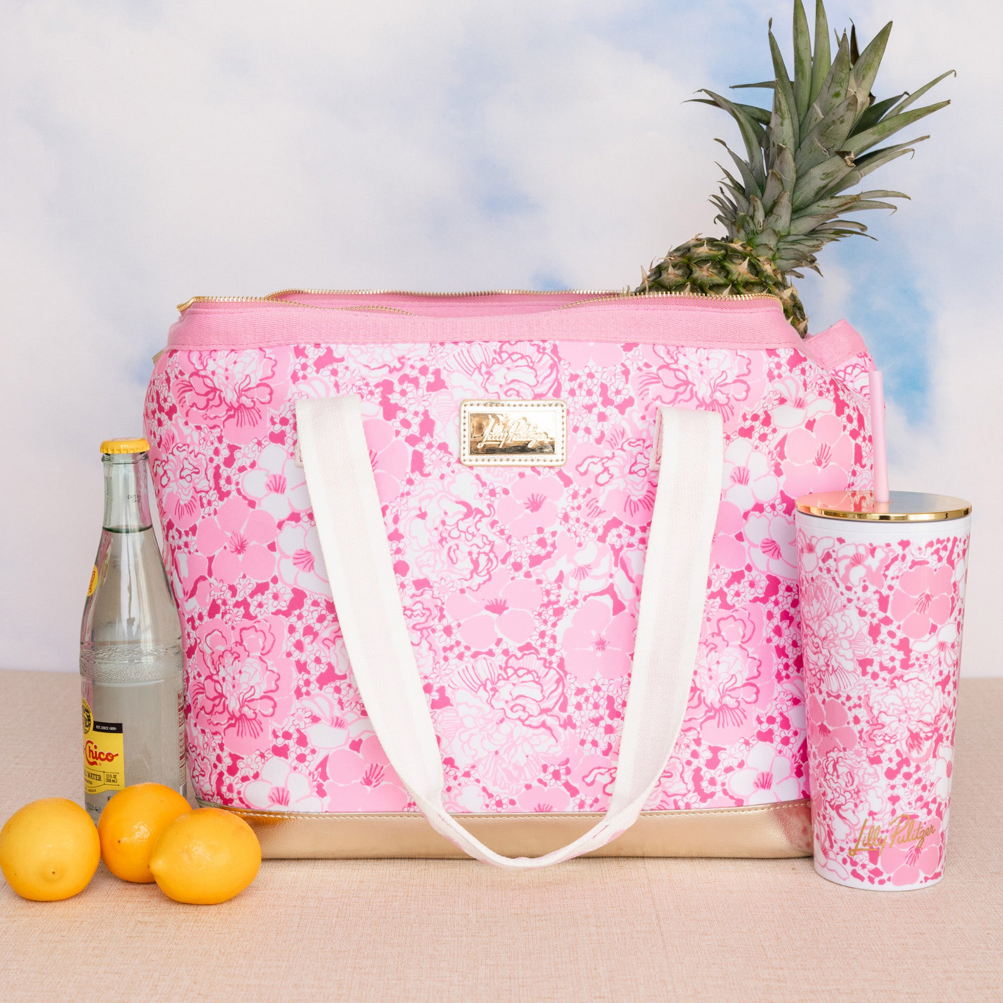 pink and white floral print cooler bag with whit strap with ric rac detail and gold bottom with matching tumbler 