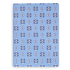 Notebook with blue and white floral pattern on a white background