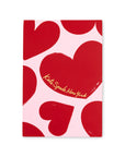 Notebook with red heart pattern and Kate Spade New York logo on a white background