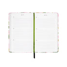 Open planner with floral design on a white background