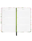 Open planner with floral design on a white background