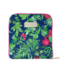 A square zippered pouch featuring a vibrant tropical botanical print with green palm leaves, red pomegranates, and small white flowers on a dark blue background. The pouch has a beige leather brand patch and a gold zipper pull.