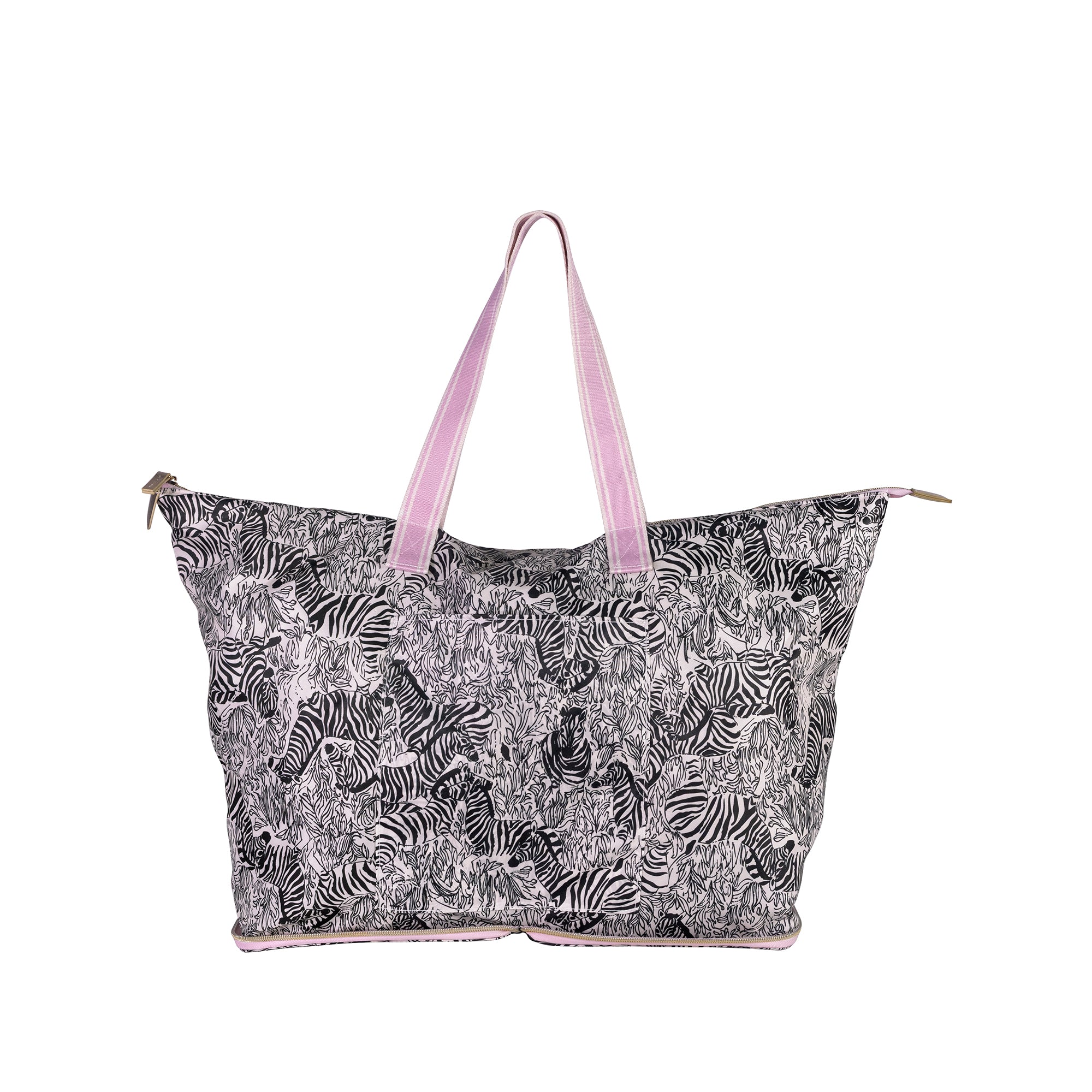 A large tote bag featuring a black and white zebra print pattern, with light pink handles and trim, shown against a plain white background.