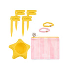 Set of yellow and pink pet accessories including a star-shaped bowl, pink pouch, and hair ties on a white background.