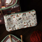 Pouch with a pattern of books and stationery items on a white background