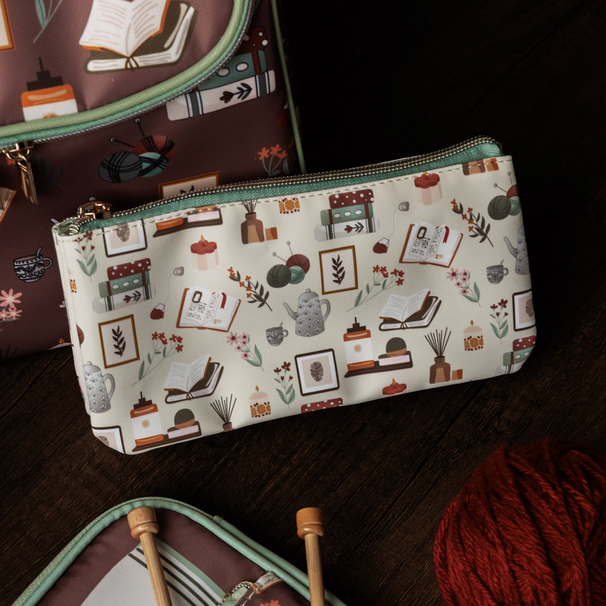 Pouch with a pattern of books and stationery items on a white background