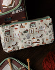 Pouch with a pattern of books and stationery items on a white background