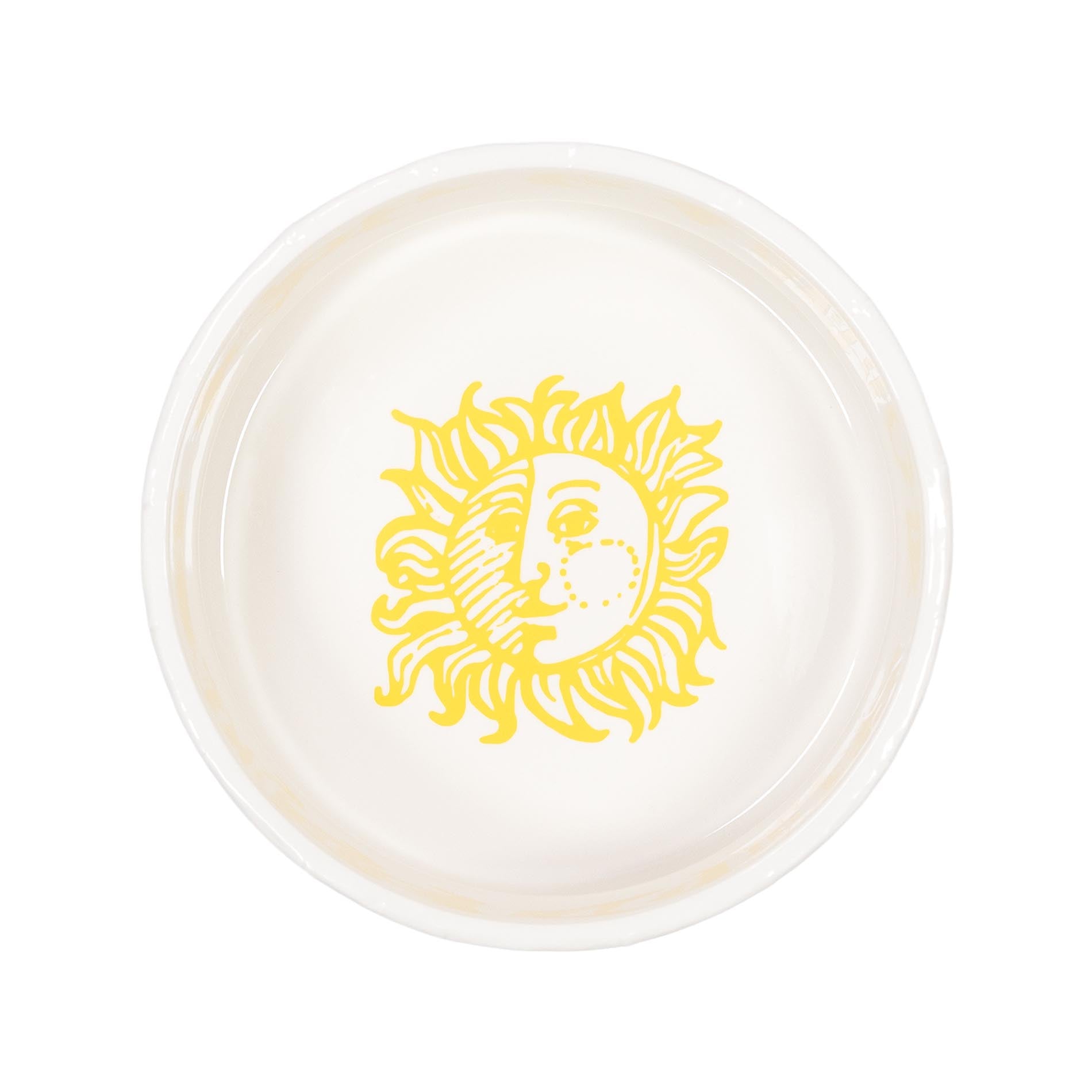 Round ceramic plate with a yellow sun design on a white background