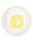 Round ceramic plate with a yellow sun design on a white background