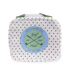 White polka dot bag with green strap on a white background