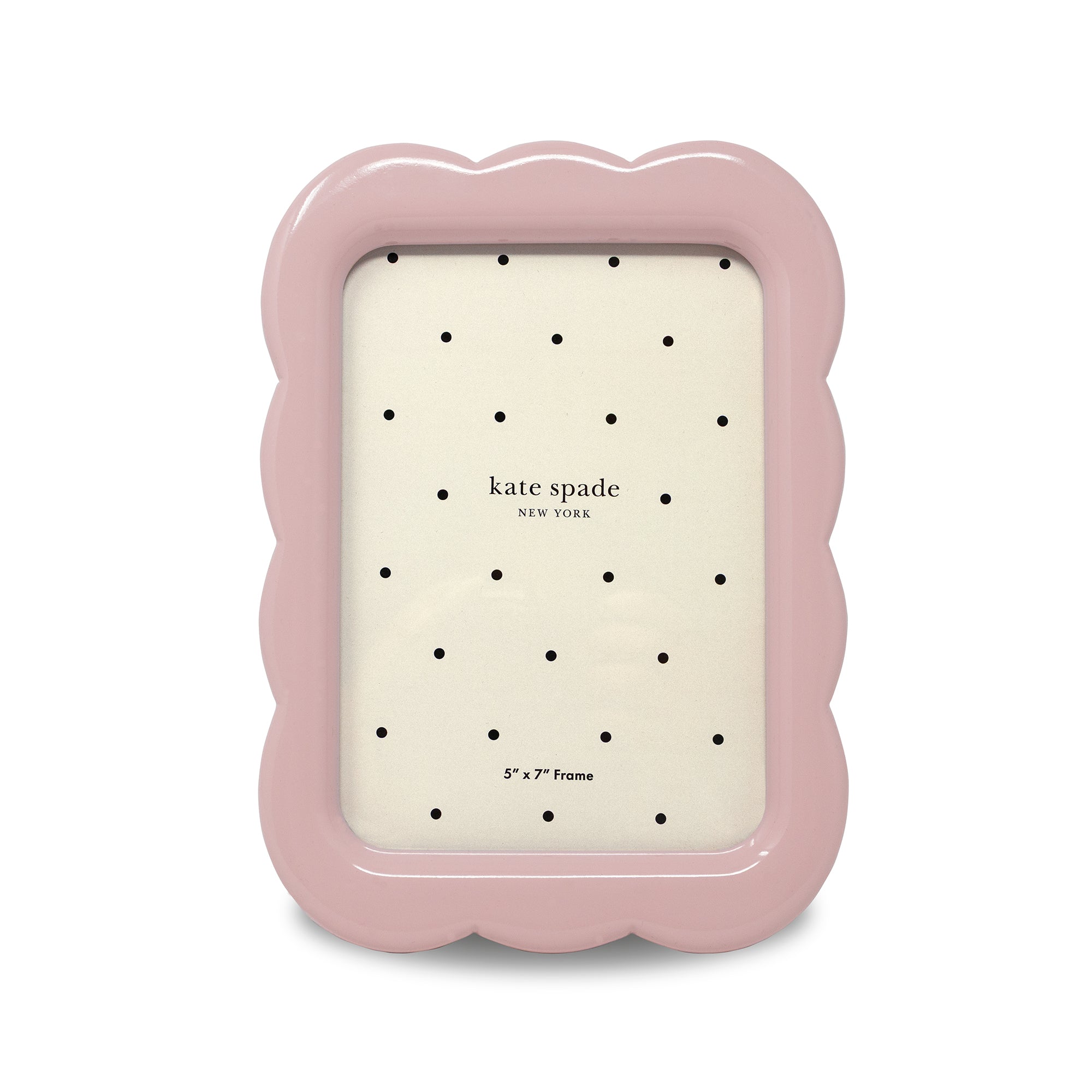 Pink photo frame with scalloped edges and 'kate spade new york' branding on a white background.