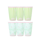 Set of three paper cups with green striped and floral patterns on a white background