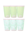 Set of three paper cups with green striped and floral patterns on a white background