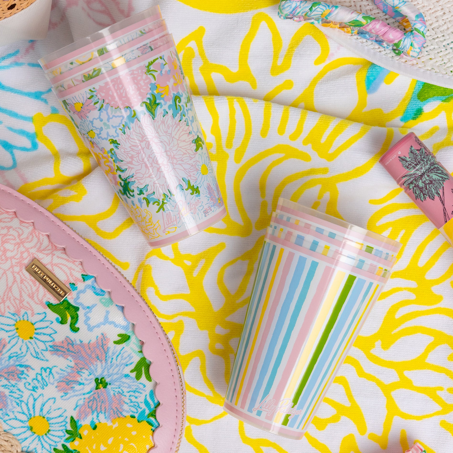 Two colorful cups, one with floral design and the other with striped pattern, on a colorful background.