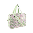 A quilted duffel bag with a light green and lavender paisley pattern, featuring light green handles and a matching shoulder strap with a gold-tone logo clasp.
