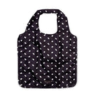 Black tote bag with white polka dots on a white background
