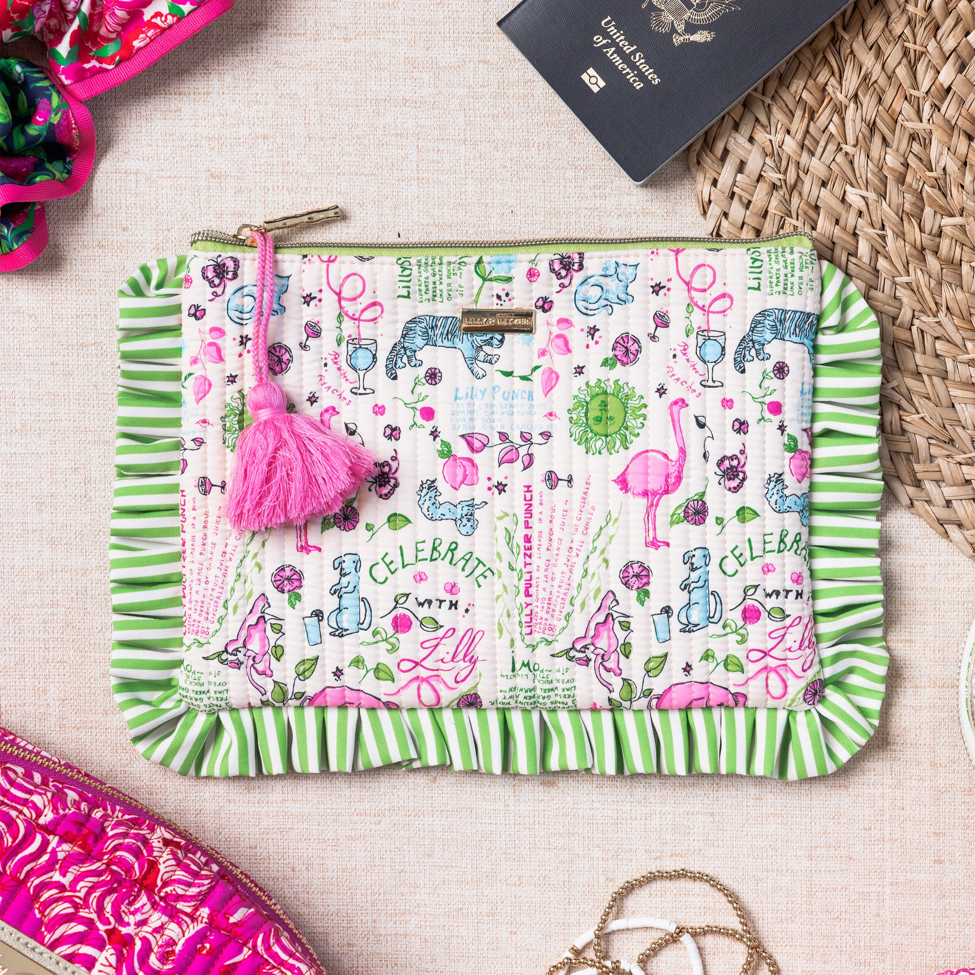 pouch with animal illustrations and a pink tassel  with a passport sticking out