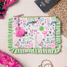 pouch with animal illustrations and a pink tassel  with a passport sticking out