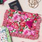 Floral pouch with red fringe and pink tassel  with a passport sticking out