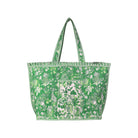 A green and white patterned tote bag with matching shoulder straps, featuring a tropical floral and leaf print, shown against a plain white background.