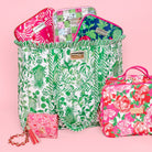 green and white tropical botanical print tote bag with ruffled trim and long shoulder straps filled with colorful LP items