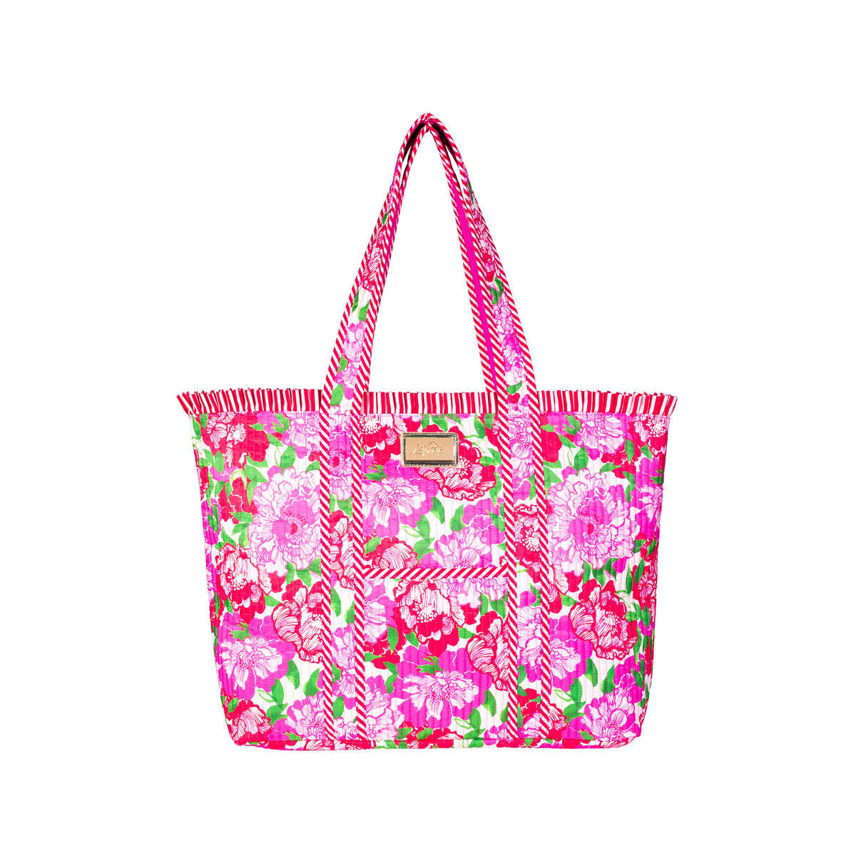 A bright pink tote bag with a floral print, featuring pink and white chevron-patterned handles and a small tan leather brand patch on the front.
