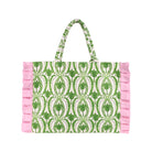 A tote bag featuring a green and white palm tree pattern, finished with light pink ruffle trim on the sides and matching ruffle handles, shown against a plain white background.