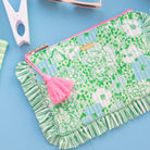 Floral patterned pouch with a pink tassel on a white background
