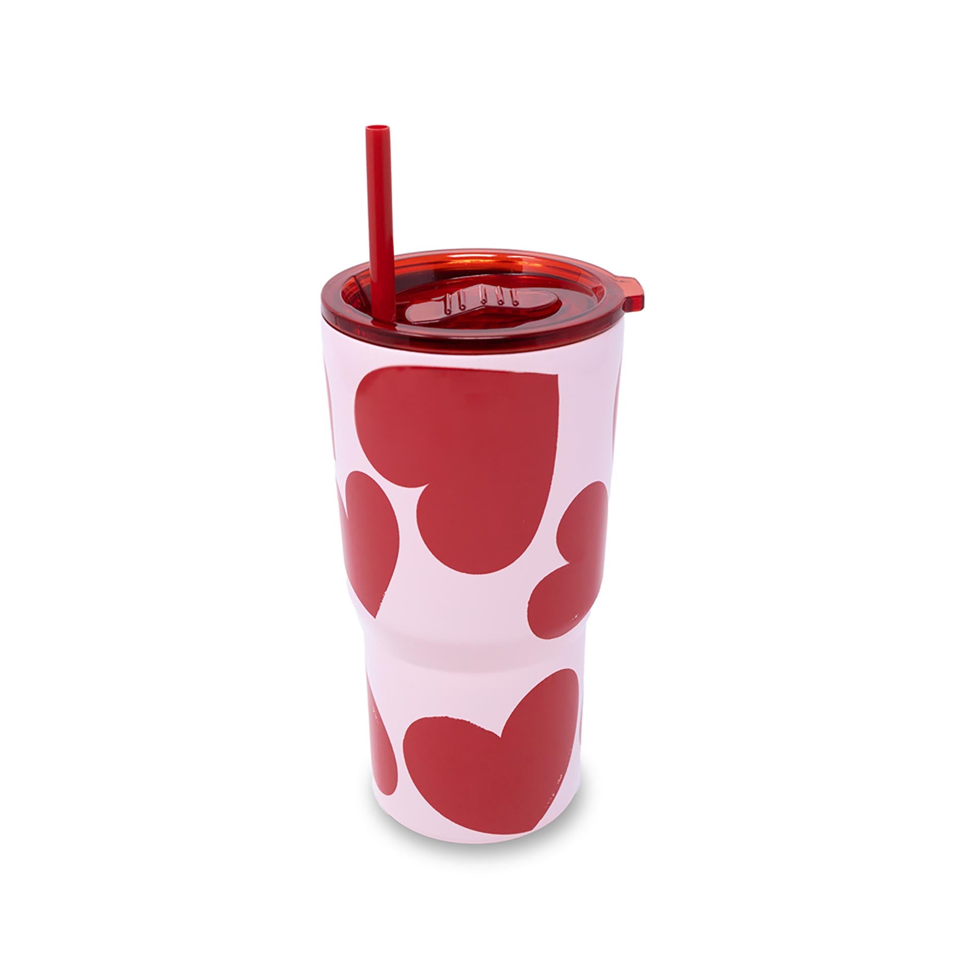 Pink tumbler with red heart patterns and a red straw on a white background