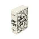 An off-white ceramic salt and pepper shaker designed like a vintage book, featuring black floral borders and the word 'SALT' printed on the cover, set against a plain white background.