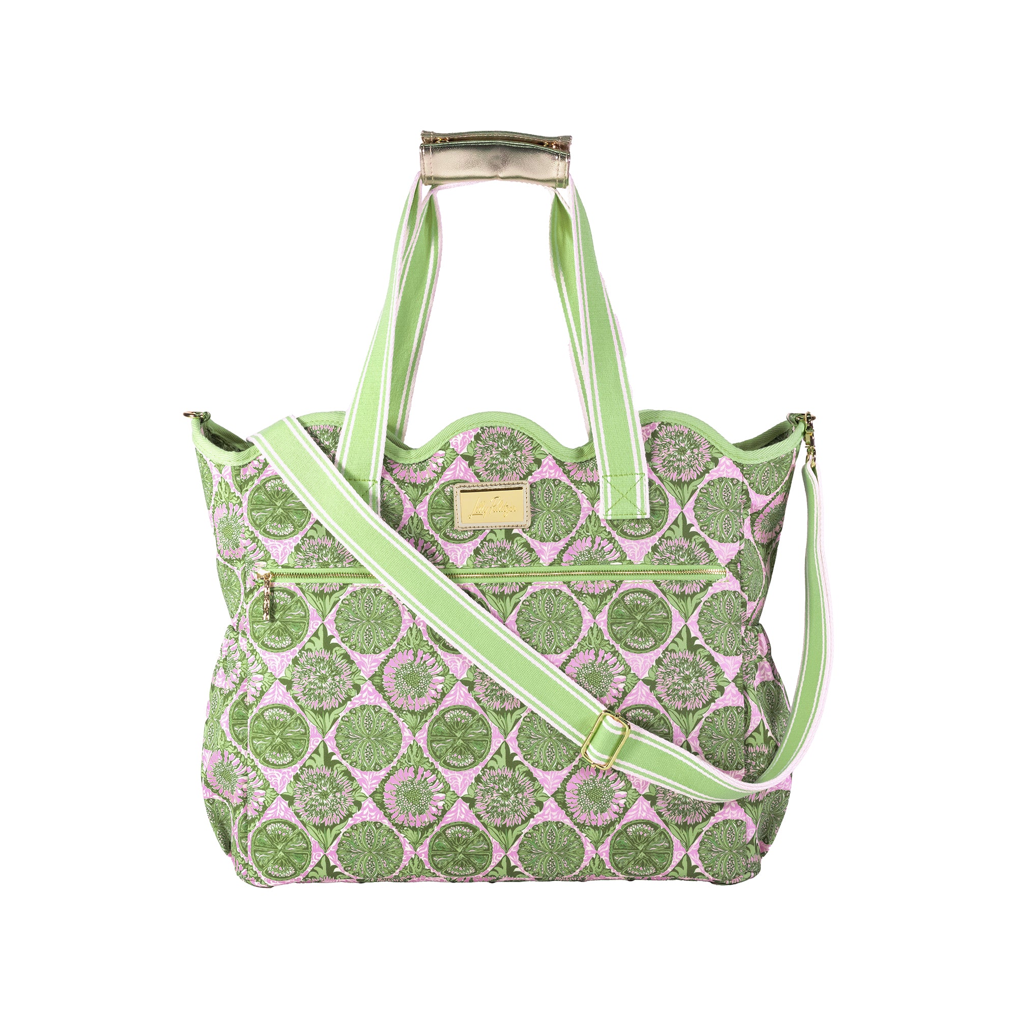 A patterned tote bag with a pink and green medallion design, featuring light green handles and a matching shoulder strap, set against a plain white background.