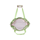 The interior view of a light green shoulder bag with a green and white patterned lining and a white interior, shown against a plain white background.