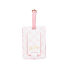 Pink luggage tag with scalloped edge design on a white background
