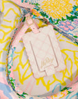 Lilly Pulitzer luggage tag on a colorful background