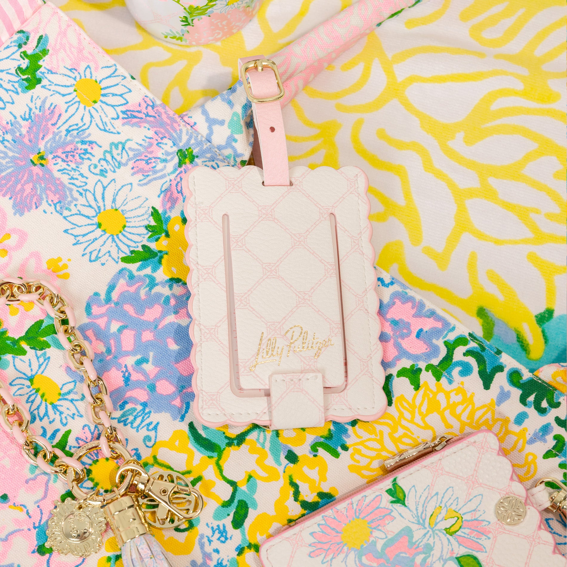 Pink luggage tag with 'Lilly Pulitzer' branding on a colorful floral background