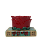 Red ceramic rose on a decorative base with rose design