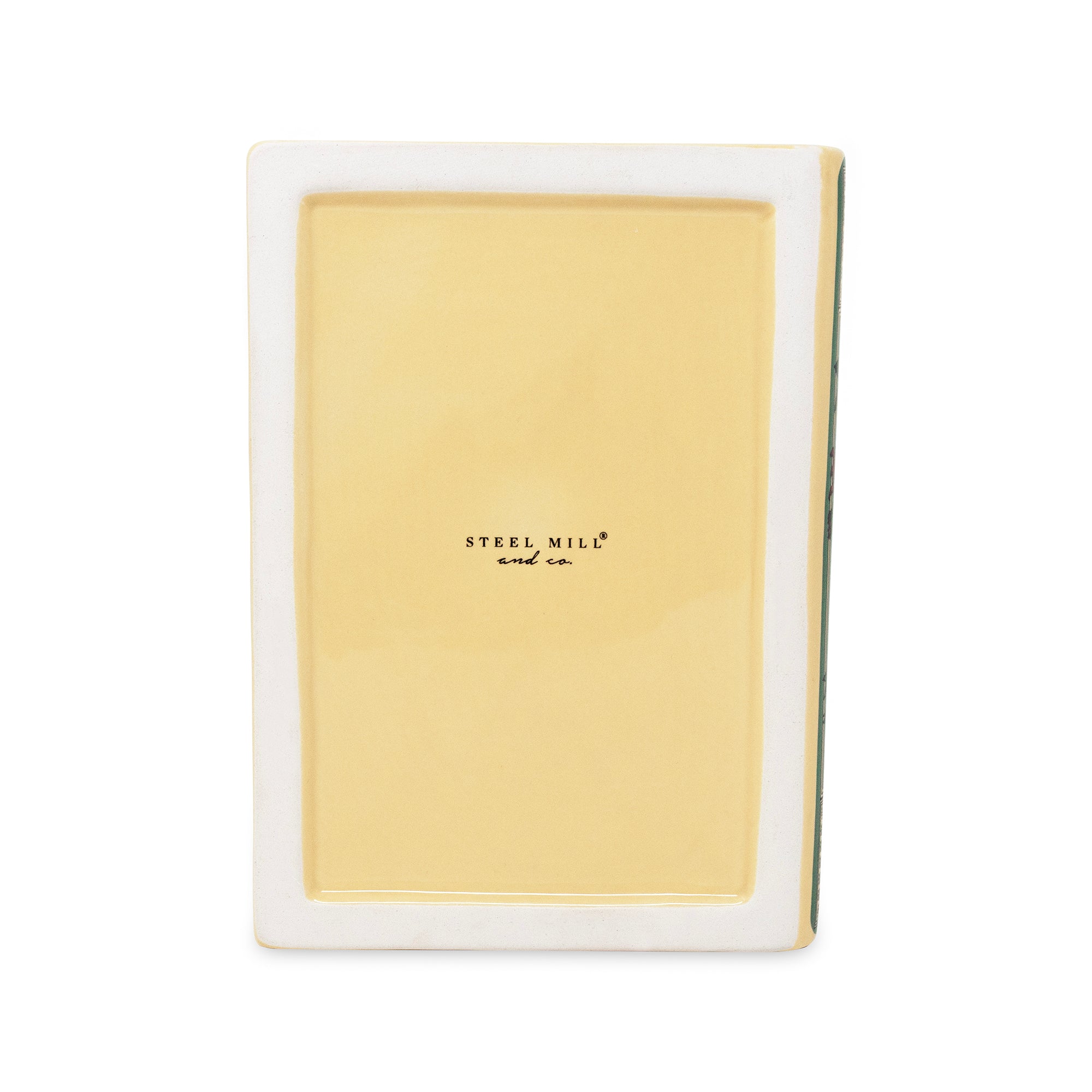 bottom of planter with a glossy pale yellow insert and a white outer border, featuring the 'STEEL MILL and co' logo in black text in the center.
