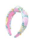 Floral patterned headband with pink center on a white background