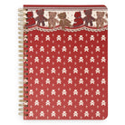 A spiral-bound notebook with a red cover featuring a repeating teddy bear print and border shown on a plain white background.