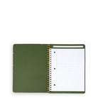 An open green spiral-bound notebook with lined pages and a pen loop on the right page, photographed on a clean white background.